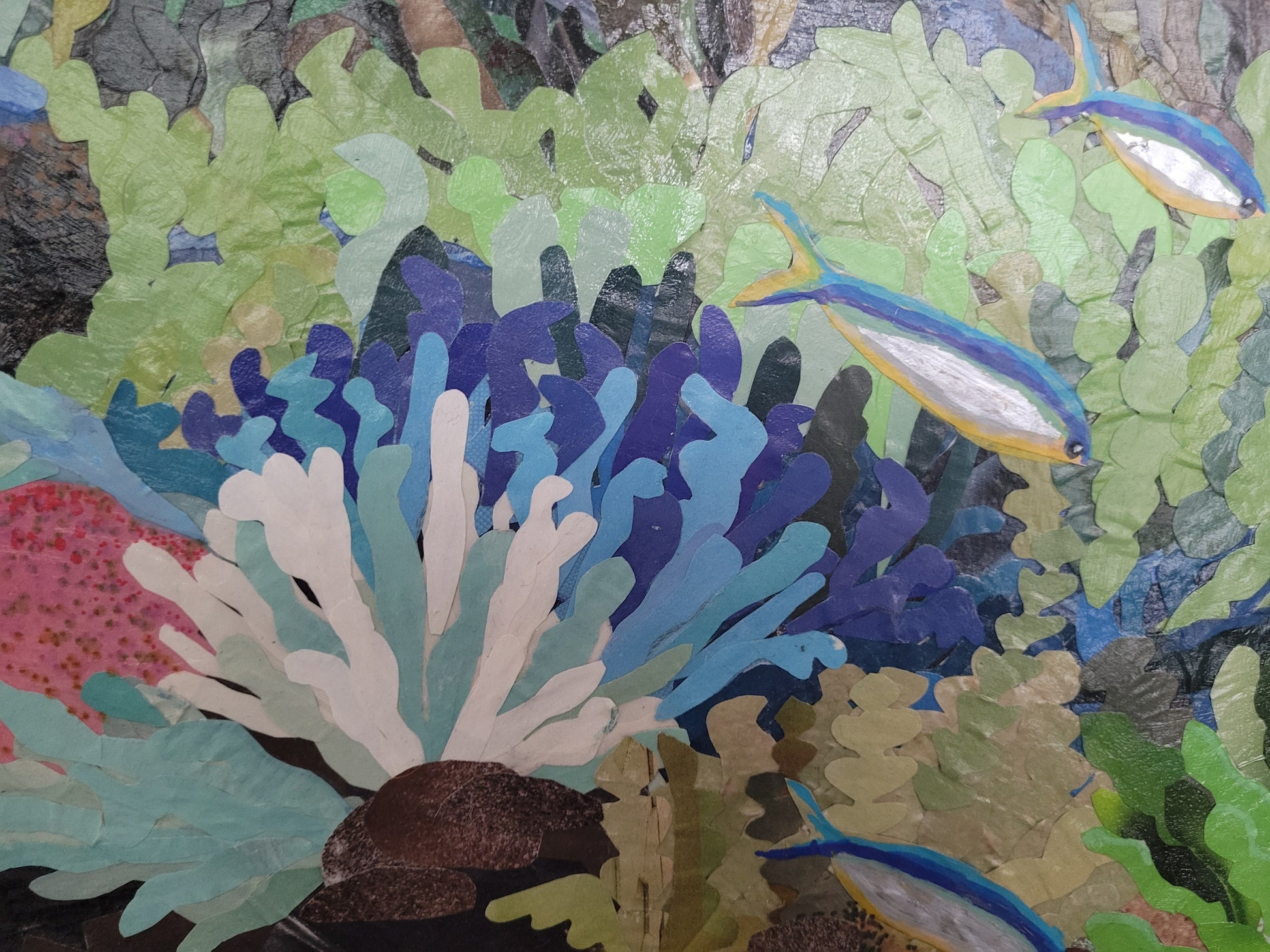 Close-up detail of Diversity by Dawn Leigh showing hand-cut reclaimed paper layered to create colorful coral and fish.