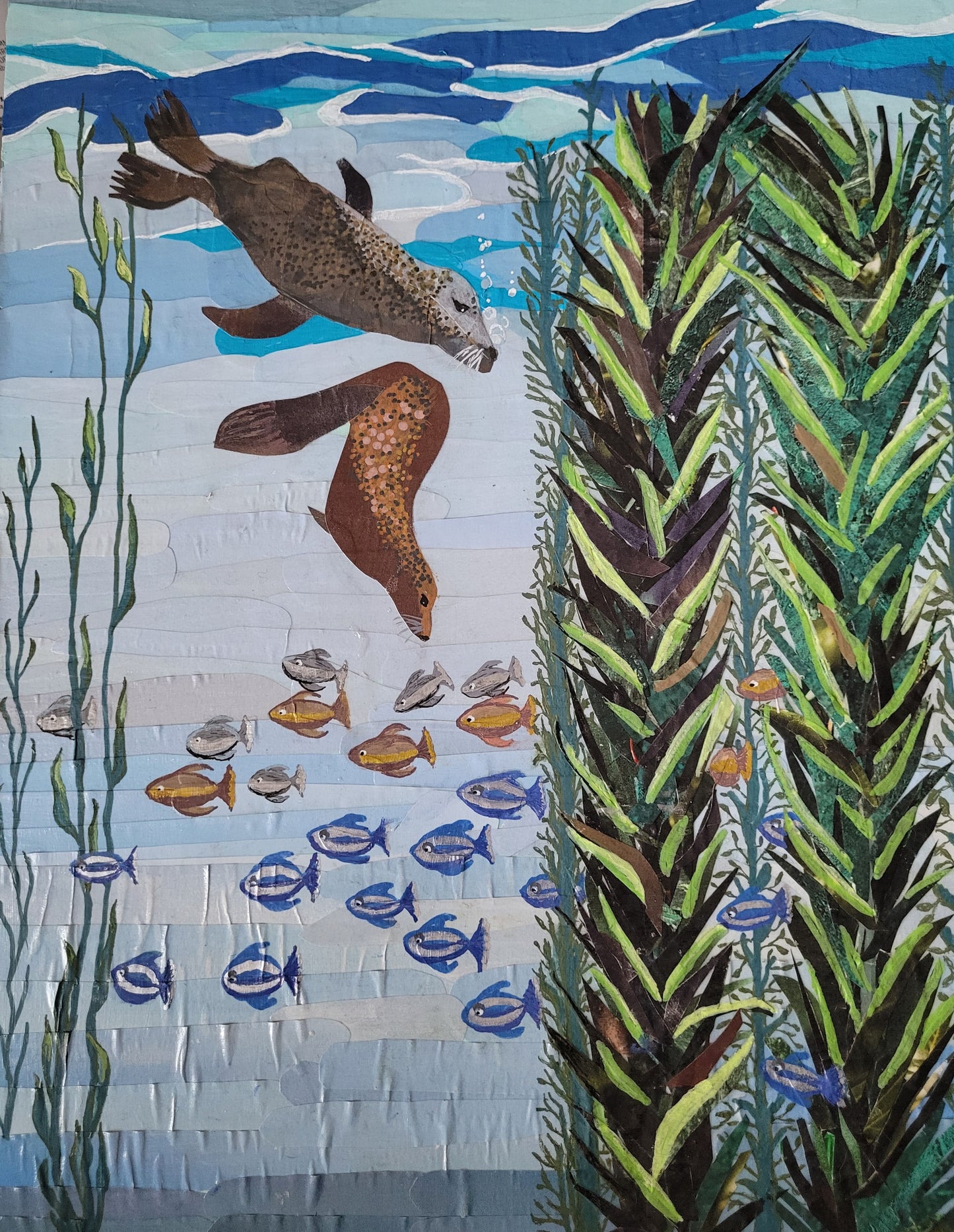 Playful by Dawn Leigh, showing hand-cut reclaimed paper harbor seals and kelp being layered into an underwater scene.